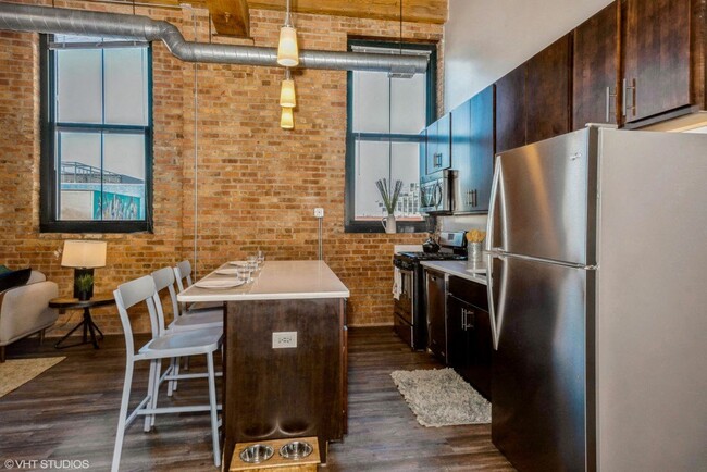 Kitchen with a breakfast bar - Carriage House Lofts