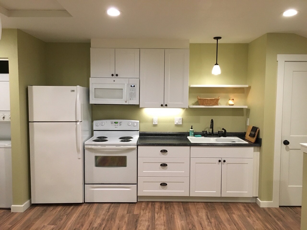 Kitchen includes dishwasher, full-sized range, refrigerator, and combination microwave/oven vent. - 9235 SW 7th Ave