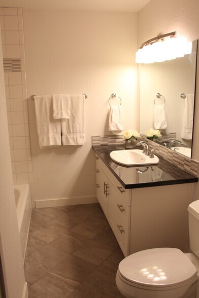 Main bathroom is complete with tile floors and granite counter top - 10418 Northeast 32nd Place