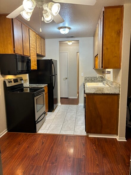 View of the kitchen and entry way from the dining room - 445 Almond Dr. #29