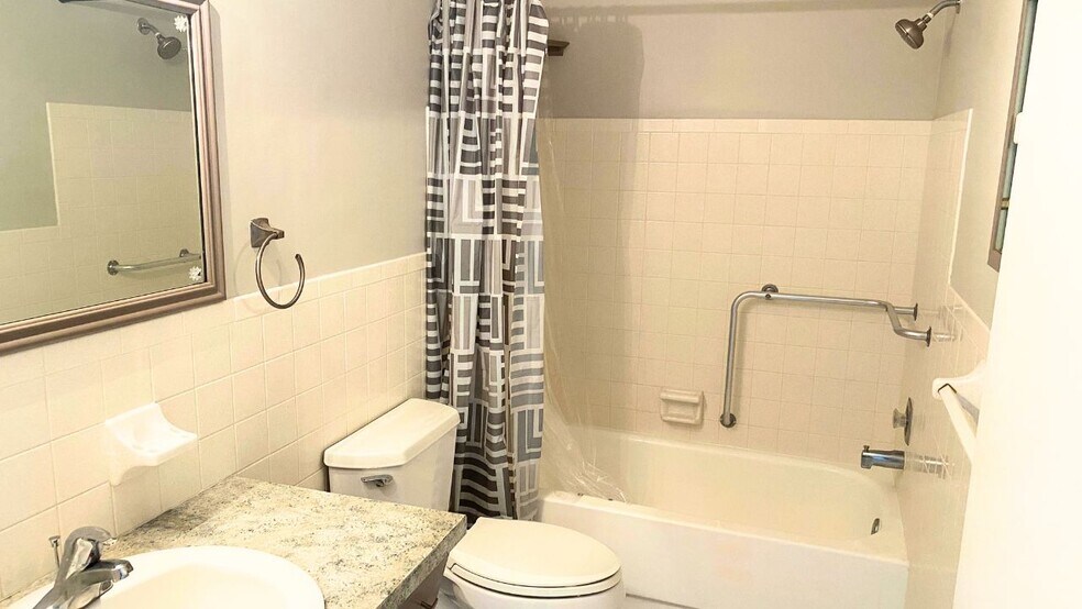 Hallway bathroom has a bathtub/shower with safety bars - 2460 Franciscan Dr