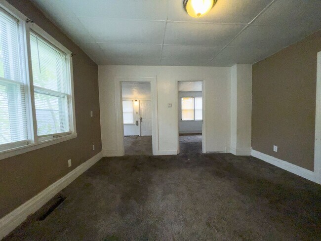 Building Photo - Fall into this cozy 3-Bedroom Home with a fenced in yard & detached garage!