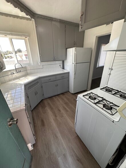 Newly painted kitchen cabinets and walls, fresh floors, and added extra cabinet - 6333 MacArthur Blvd