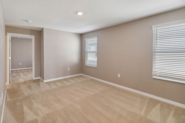 Building Photo - Like New 4/3 Townhome in Gated Community W/ Community Pool