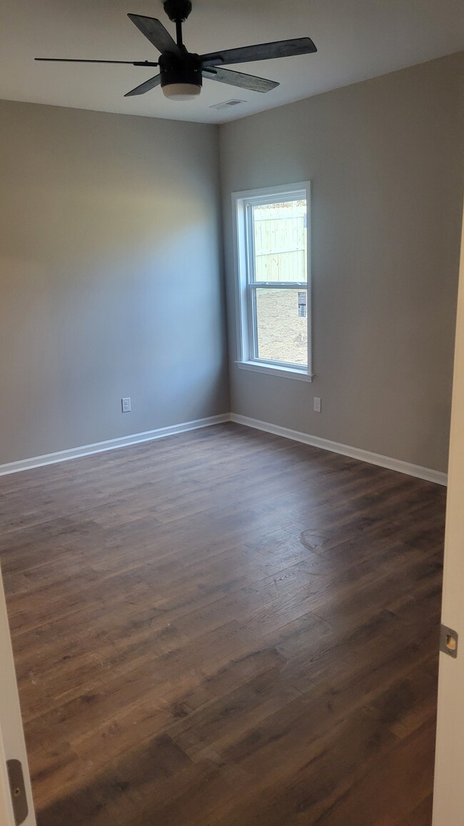 Master bedroom with laminate floors and ceiling fan - 203 Payne St