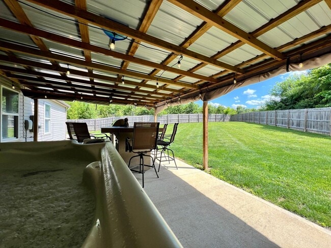 Building Photo - 3 bedroom home w/ privately fenced yard + hot tub.