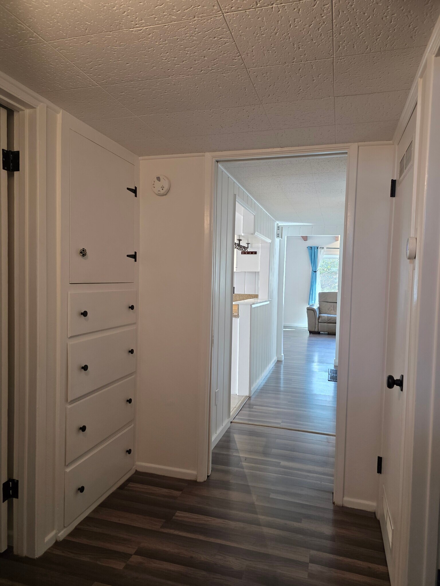 View down hall leaving restroom, with drawers and cabinet storage. Bedroom 2 to right, 3 to left. - 456 E Indian Rock Rd