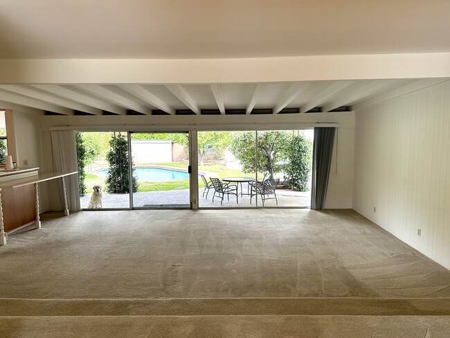 Family room; counter and kitchen to the left. Pool/backyard just beyond. - 5182 Woodley Ave