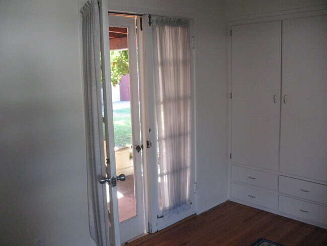 French Door from bedroom to backyard covered patio in front of shady glen backyard - 3121 W Wyoming Ave