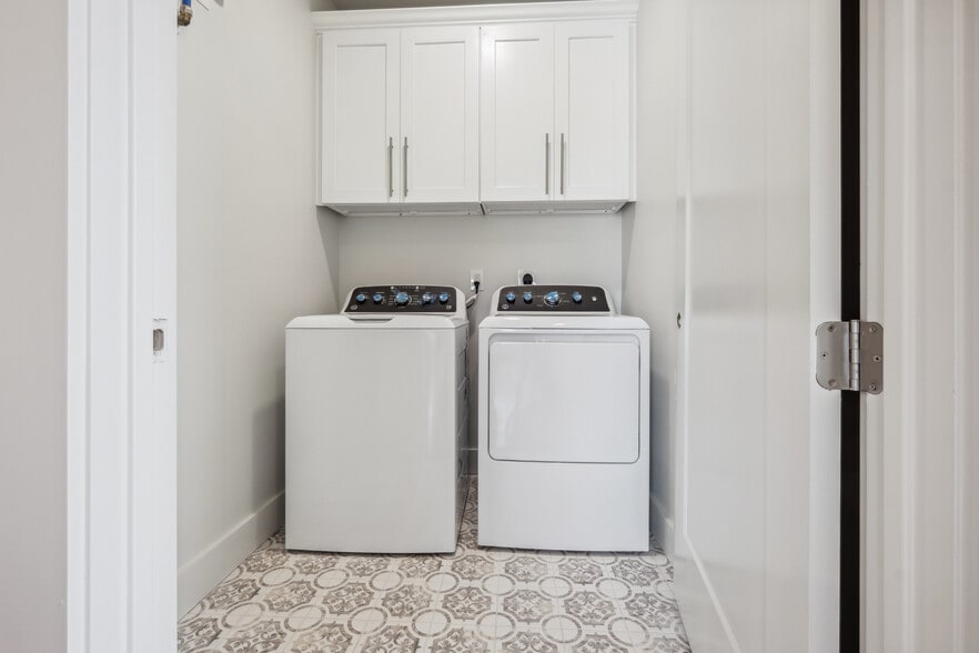 Laundry room with side by side washer/dryer and custom cabinets - 428 W Solidelle St