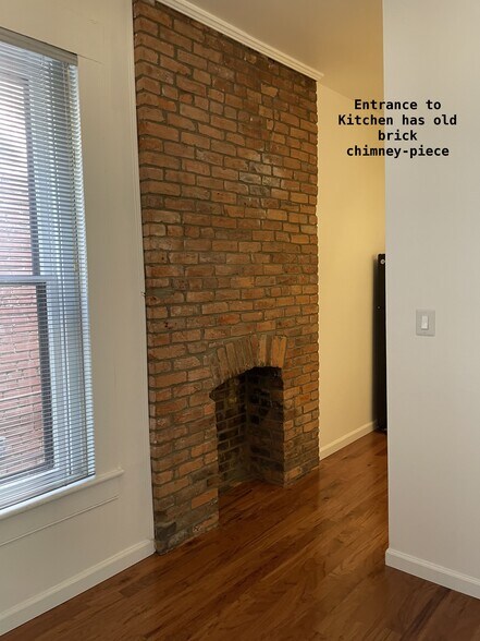 Exposed original chimney piece leadinginto kitchen - 810 E Washington St