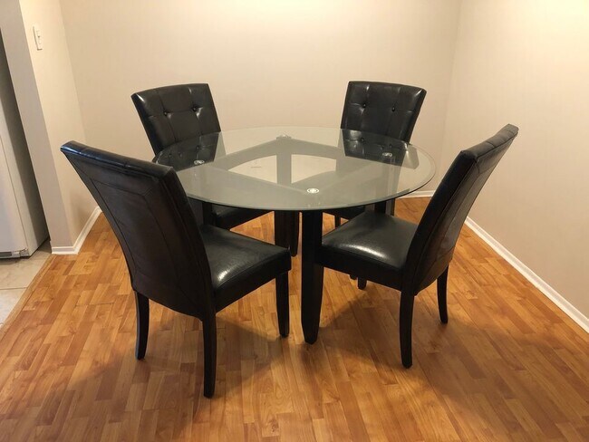 Dining space with glass table and leather chairs - 8315 Karam Blvd