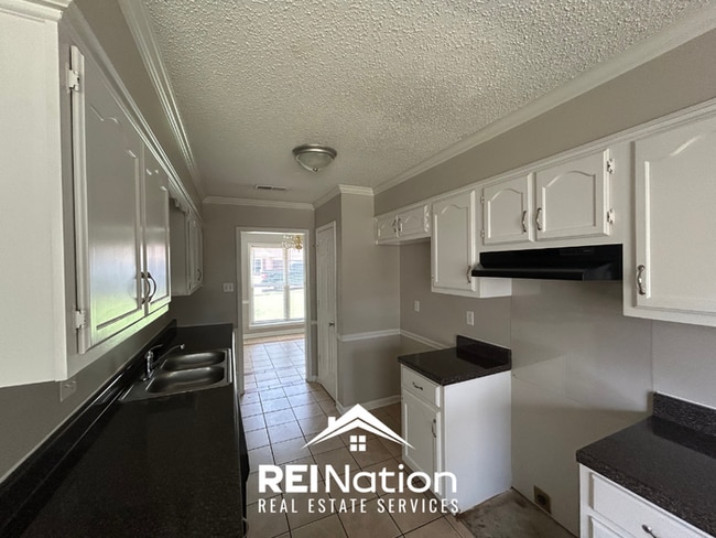 Building Photo - Spacious 4BR/2BA Near Southwind | High Ceilings, Brick Fireplace & 2-Car Garage