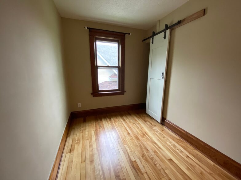Second bedroom, with barn door and closet - 783 Edmund Ave W