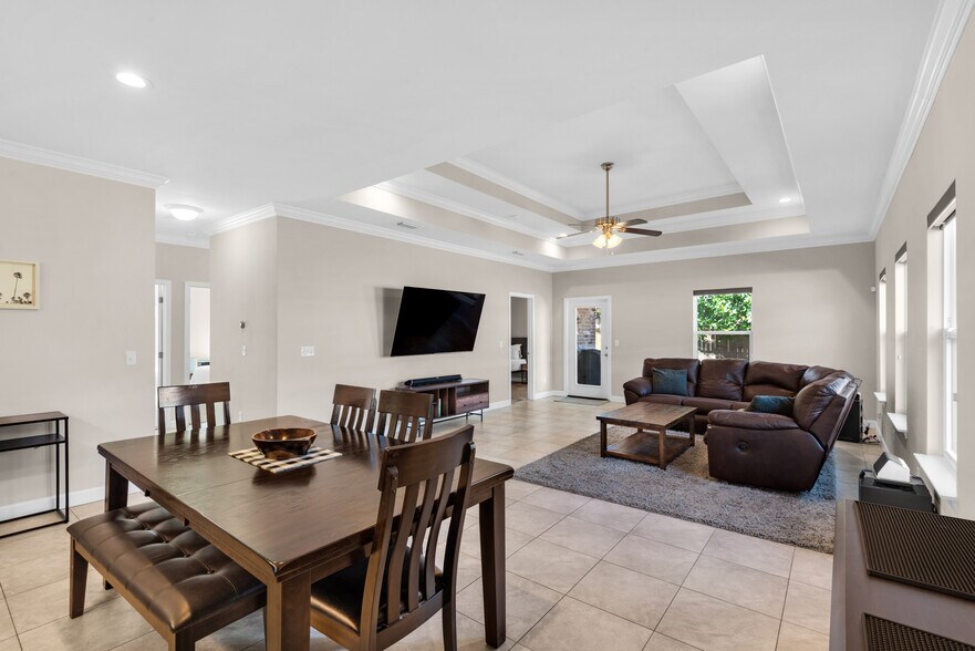 Open space for entertaining, with dining room table, island, and bar cart - 28 Snook Rd