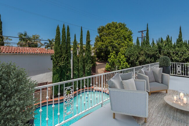 Primary Bedroom Balcony: Virtual Staging - 321 S Swall Dr