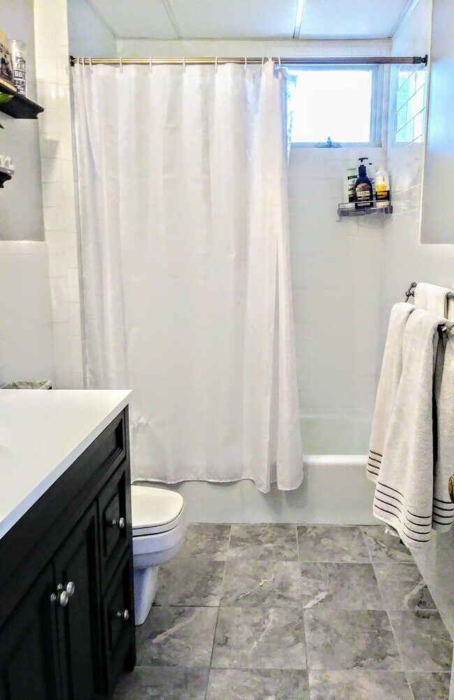 Renovated subway tile full shared bath - 2592 Massachusetts Ave