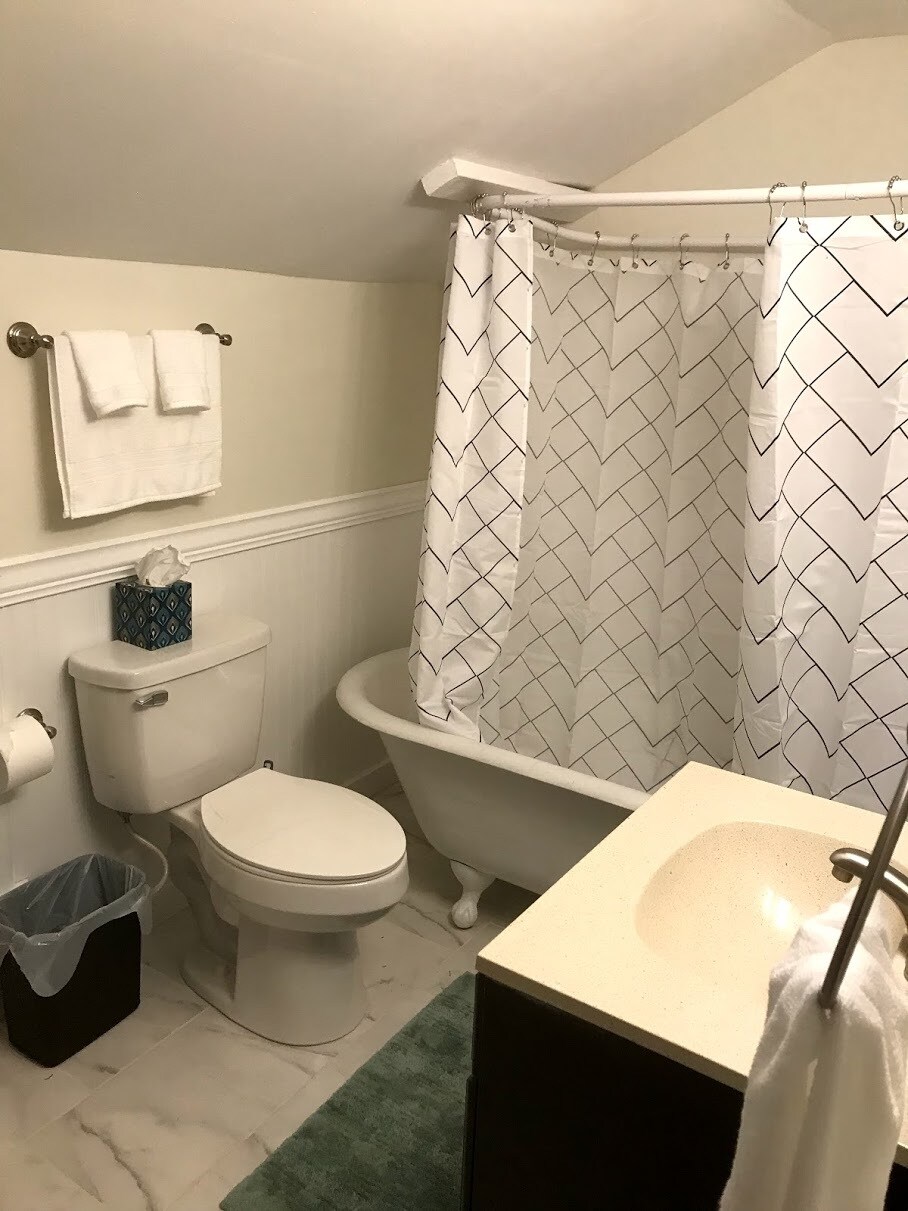 Shared Upstairs bathroom with new tile flooring and claw foot tub - 526 Monroe St