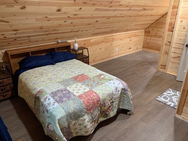 Large bedroom area with closets and large window with a country view over the neighborhood - 135 Lock Seven Ln