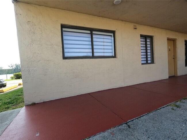Building Photo - 9911 W Okeechobee Rd