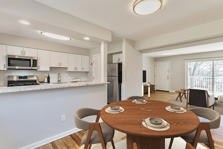 Elevate your lifestyle at Eagle Rock Apartments at North Plainfield. This stunning modern kitchen and dining area are perfect for entertaining. Enjoy spacious living with contemporary finishes. Schedule your tour today and see for yourself! - Eagle Rock Apartments at North Plainfield