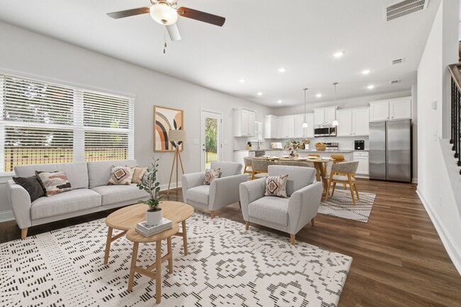 A refined living area offering a graceful view of the homes living and dining space - Alma Farms