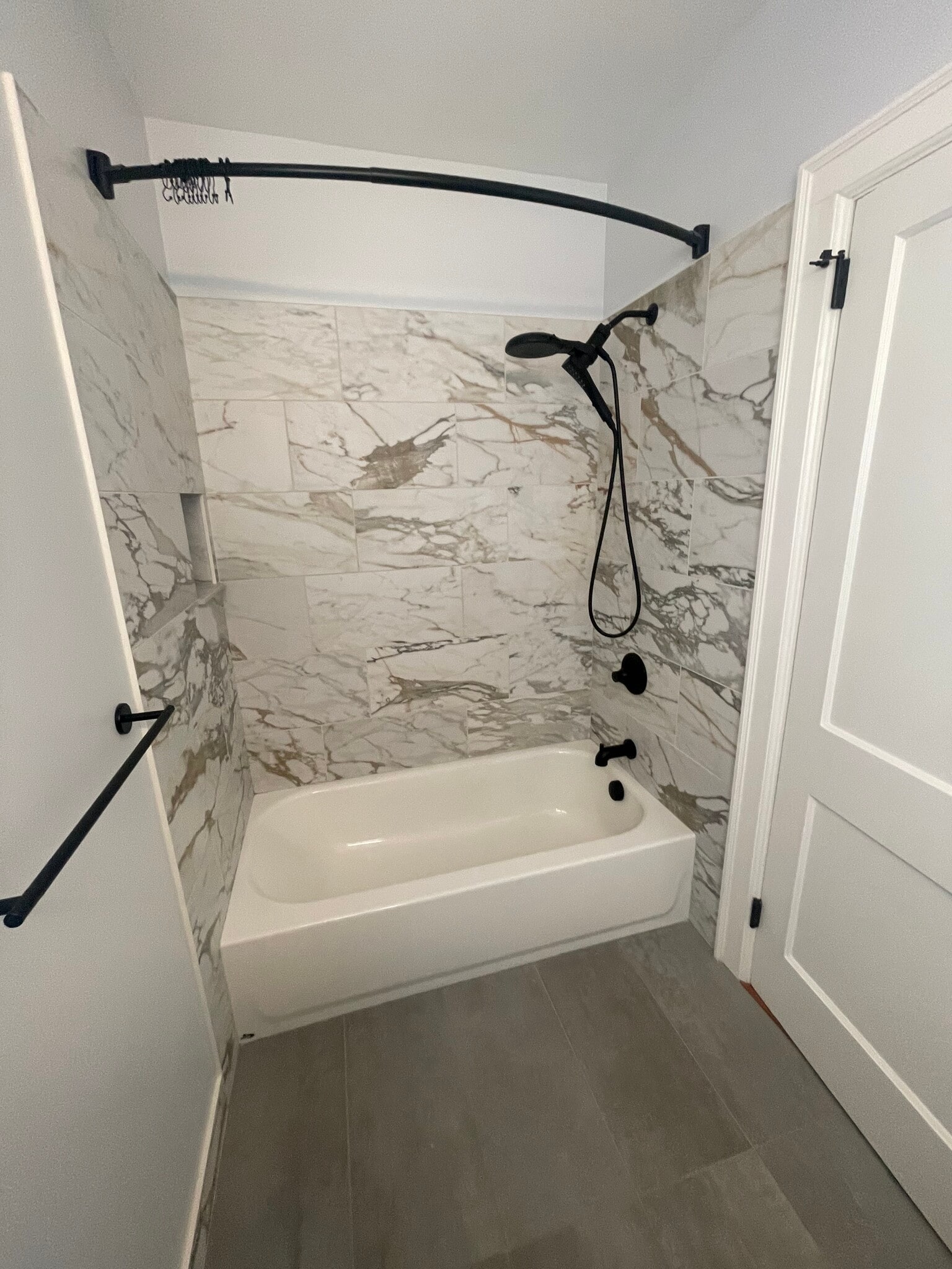 this is what the finished bath will look with the white carrara tile shown in the pic below - 418 Clement Ave