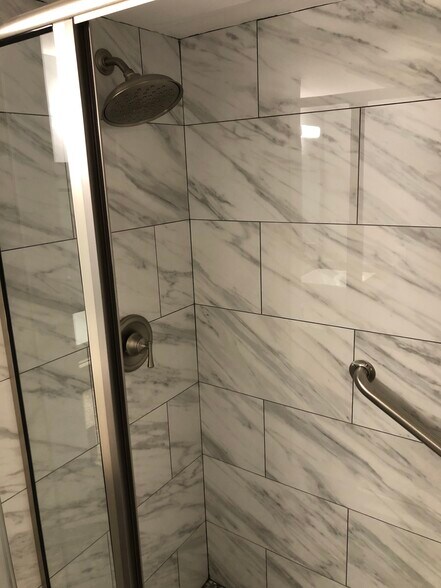 Bathroom with bench and grab bar - 1950 N Andrews Ave