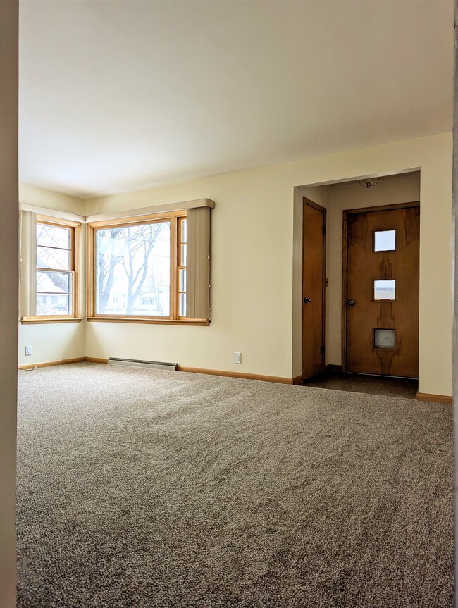 The living room includes a cozy entryway with a coat closet. - 910 Maple St