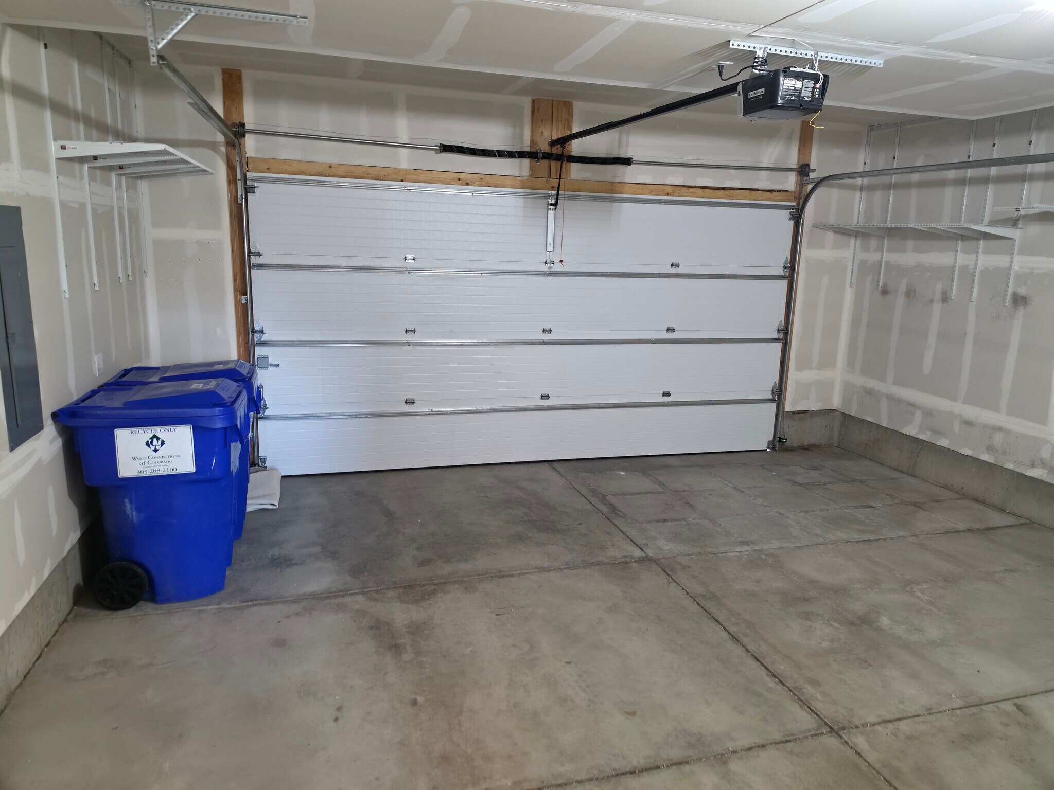 Two-car garage with trash & recycling bins, storage shelving - 2220 S McIntyre St