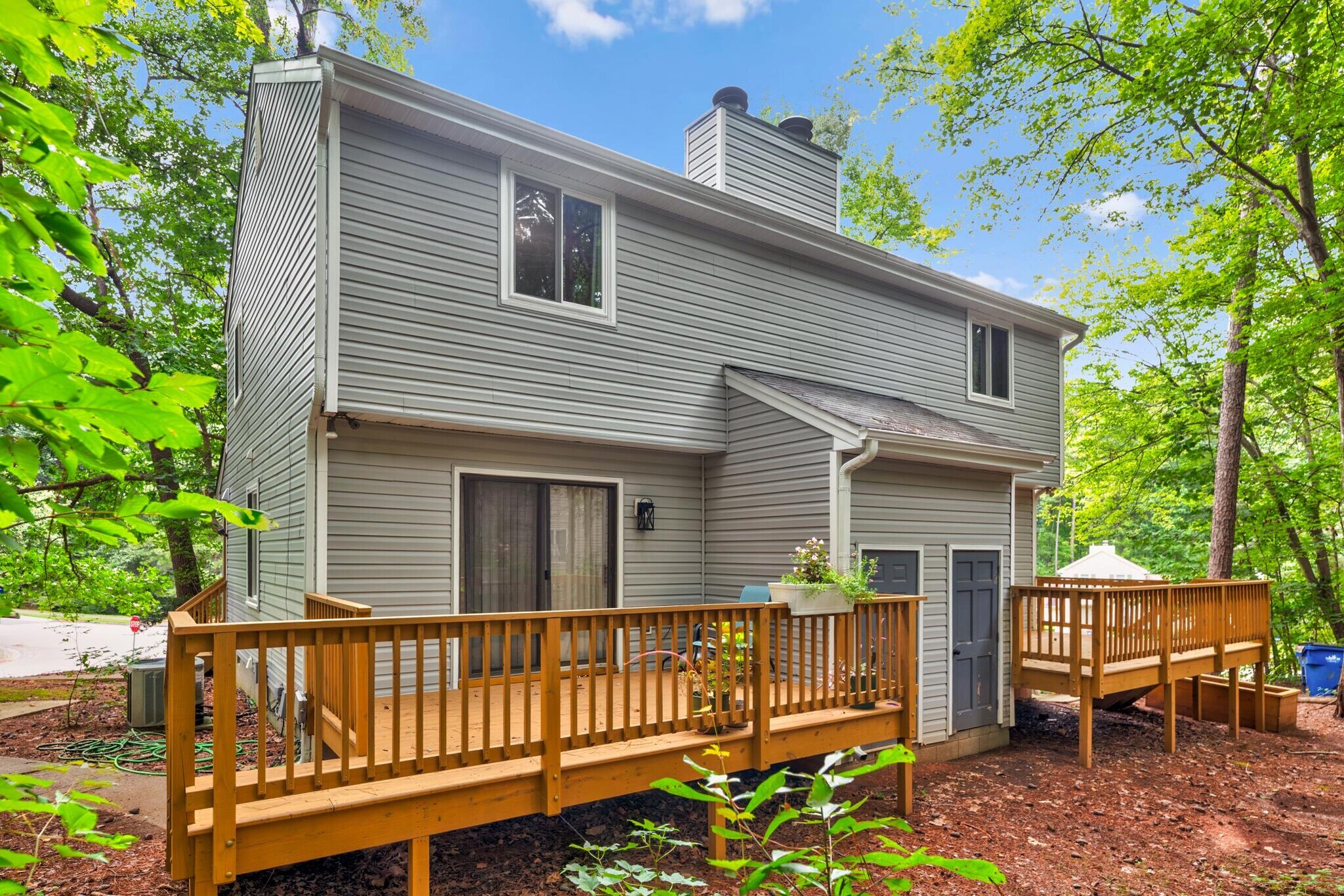 New back deck with ample space to entertain and a lovely wooded yard + storage room! - 4115 Arckelton Dr