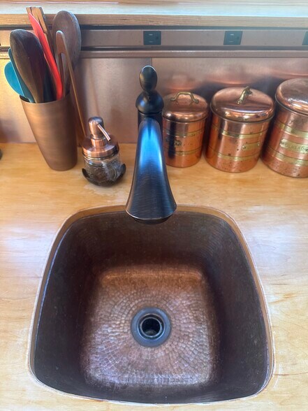 This hammered copper sink was the second purchase for The Lucky Penny, right after the arched door. - 833 Valencia St