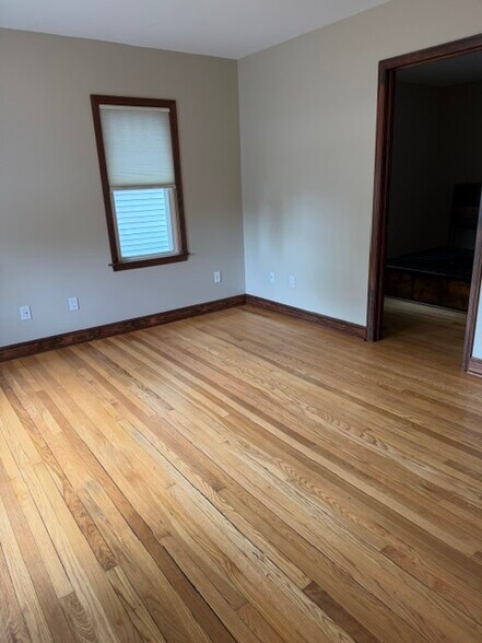 Main level living room with original hardwood floors and large windows and main bedroom located - 4238 State Park Dr