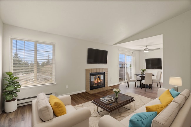Experience warmth and style in this charming living room with a cozy fireplace and elegant furnishings. - Monte Vista Apartments