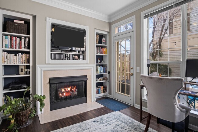 Building Photo - This inviting two-level townhome offers comfort and style, featuring gleaming hardwood floors on ...