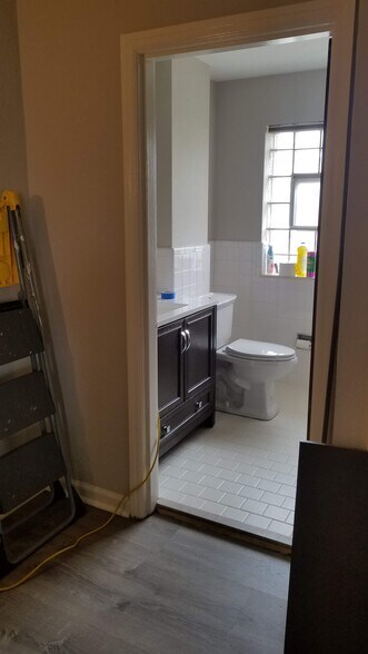 Peek at bath with new vanity. Linen closet is in foyer to the right of bath. Tub shower combo. Glass block window allows for privacy with ventilation window. - 3443 Lawn Ave
