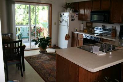 Eat in kitchen with stove, refrigerator, dishwasher, microwave and sliding door to deck. - 979 11th Ave S