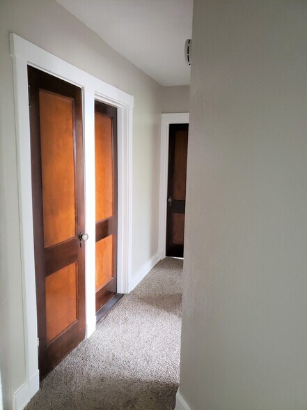Hallway leads to the bathroom and three bedrooms. It also includes a hallway linen closet - 201 Richbarn Rd