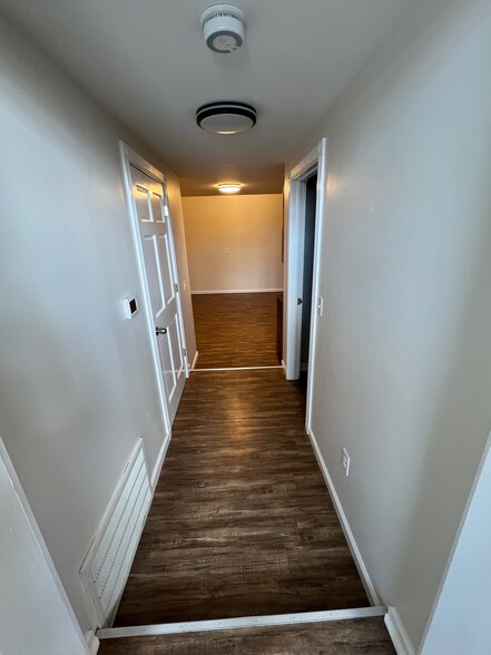 Hallway from Living Room to Kitchen with Utility Closet to the Left and Bedroom to the Right - 1216 Turner St