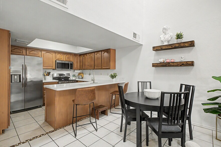 Kitchen and dining room. Add the leaf to seat 6 at the dining table.   (Comfortably seats 8 in this - 819 N College Ave