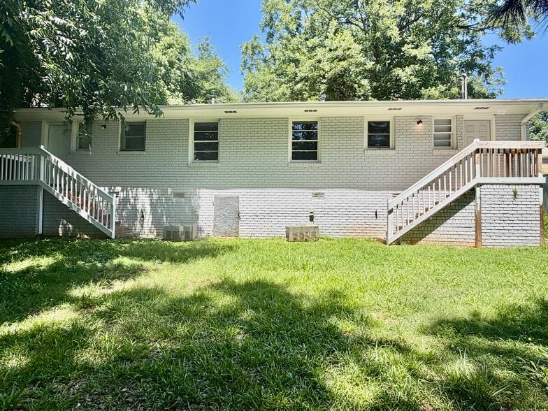 Rear Exterior- large backyard with elevated deck access. - 125 Trio Ln
