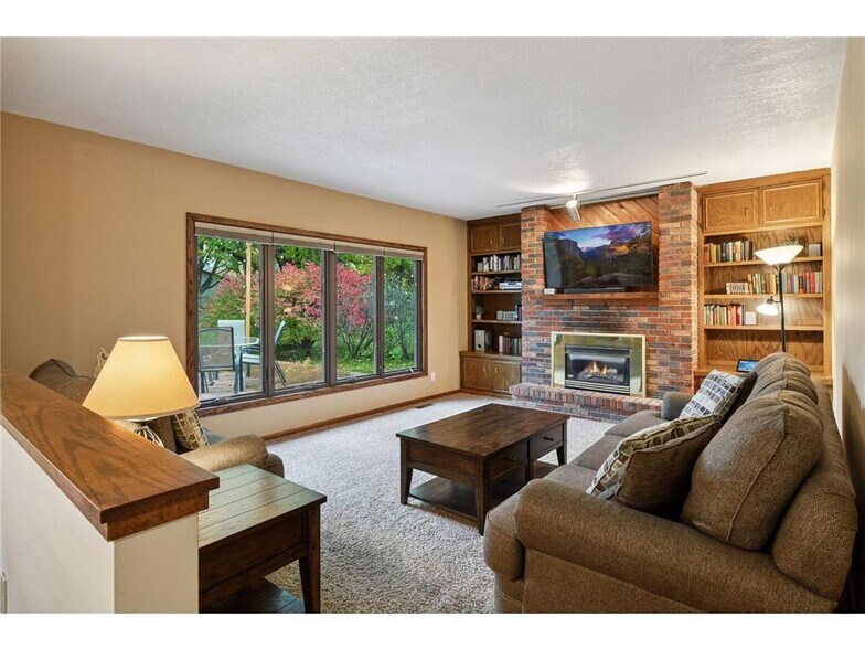 Main floor family room with gas fireplace - 9933 Balmoral Ln