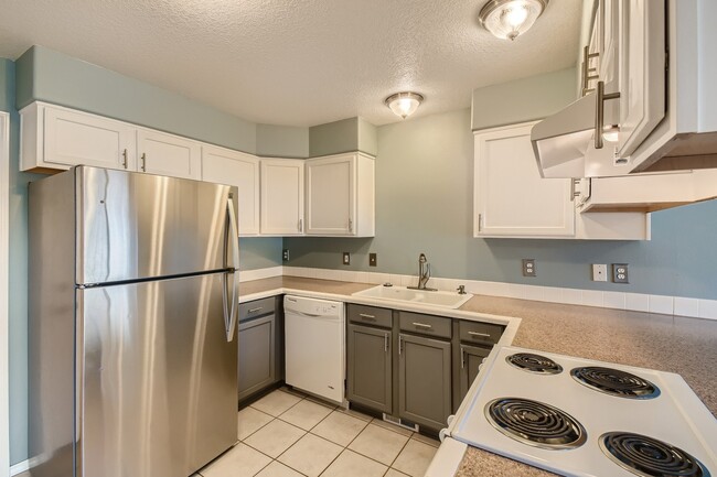 Kitchen w/ stainless fridge - 1437 NE Birkshire Ct