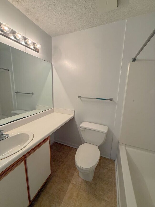 Building Photo - Top floor 4 bed 4 bath condo! On Wolfline, perfect for roommates!