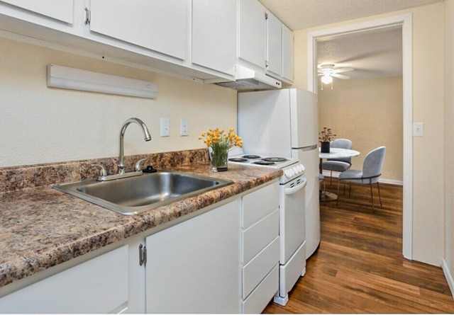 Prepare meals with ease in kitchens equipped with contemporary appliances, ample cabinetry, and functional layouts. - Palatka Oaks Apartments