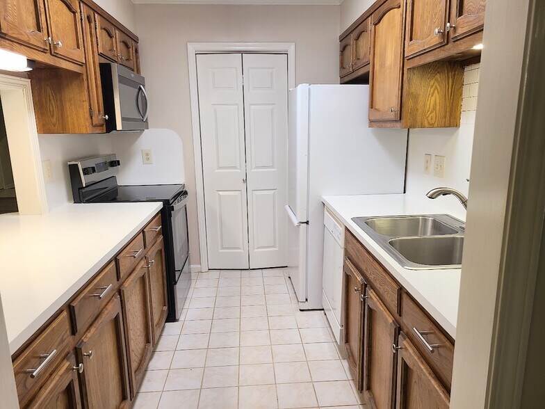 Galley kitchen with tons of storage and laundry room - 12439 Coursey Blvd