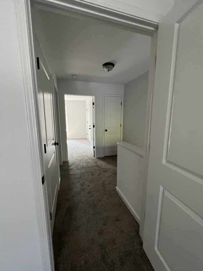 Upstairs hallway with a linen closet as well as larger closet. - 2 Henry St