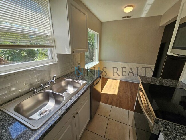 Building Photo - REDUCED $200!!  Cute 3/1 with updated kitchen & bath, enclosed front lanai & one car garage!!