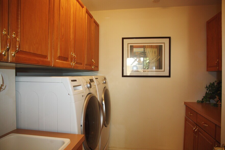 Full laundry room with laundry sink and storage - 2662 NW 42nd St