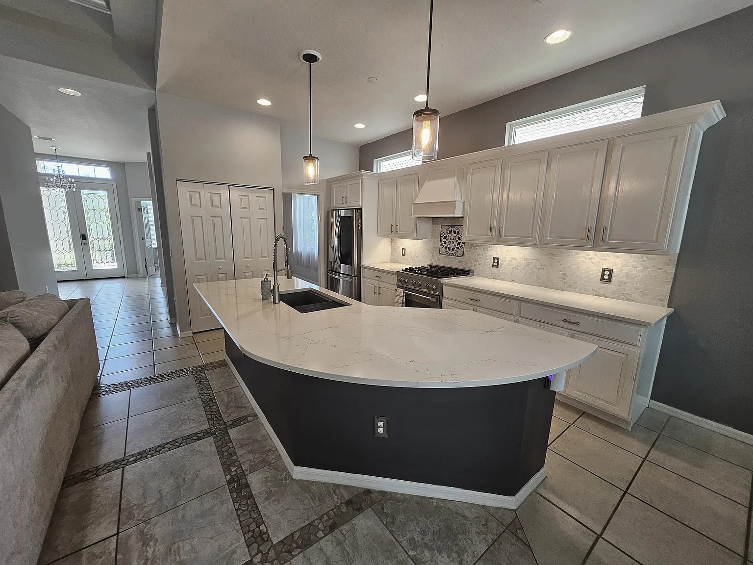 Custom renovated kitchen with a curved quartz countertop and new appliances - 4353 Reflections Pky